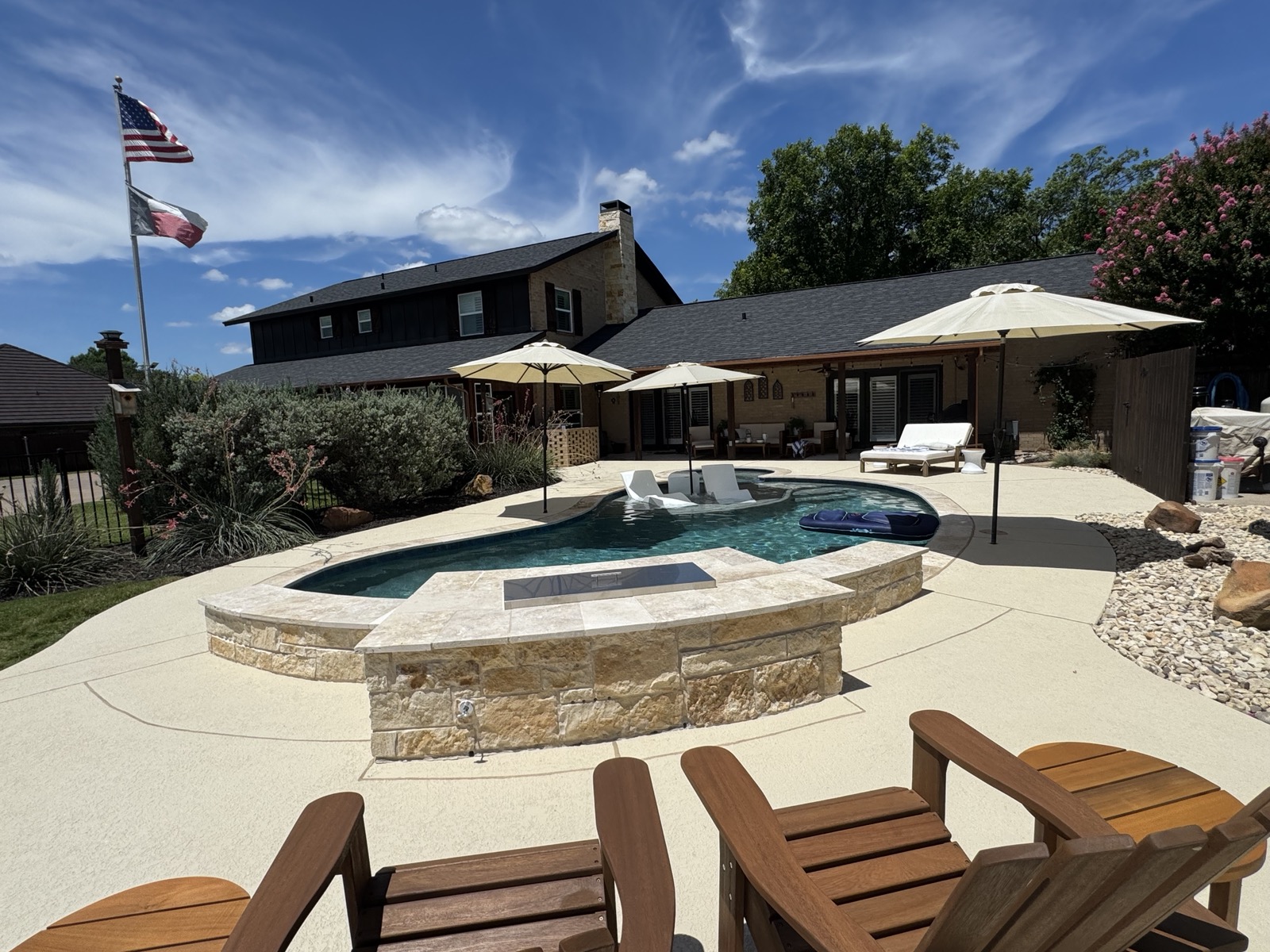 Pool and spa with limestone coping wall and Adirondack seating
